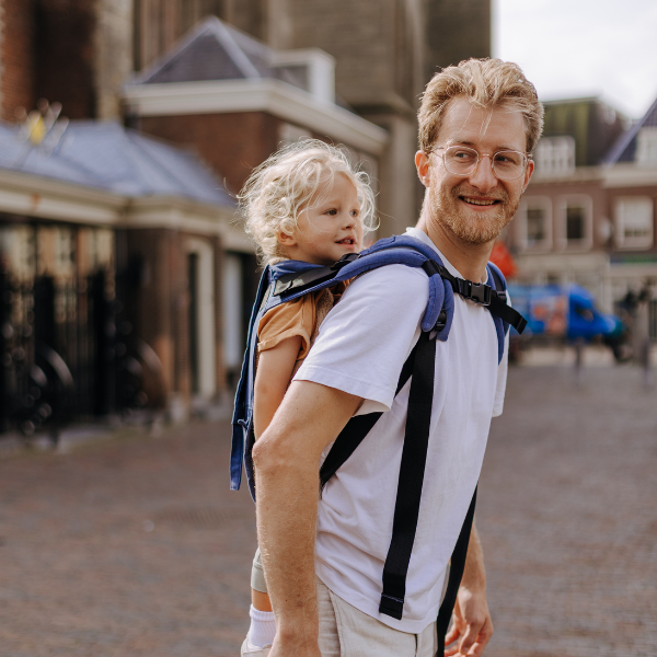 Dad carrying toddler in the city