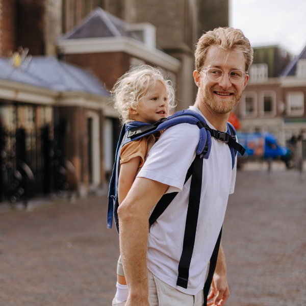 Dad carrying toddler in the city 