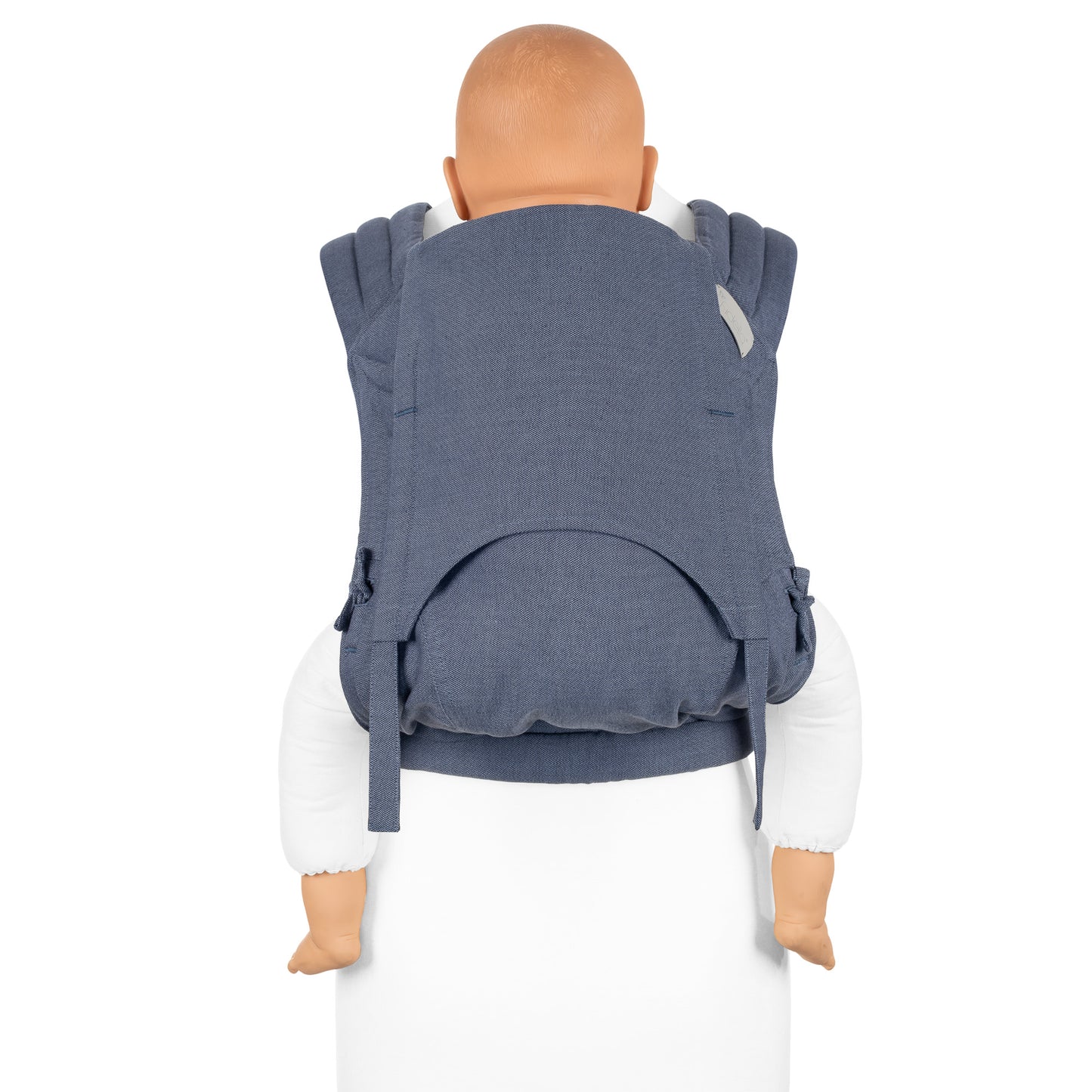 A toddler is carried in Fly Tai Mei Tai Sling baby carrier Design Chevron denim blue