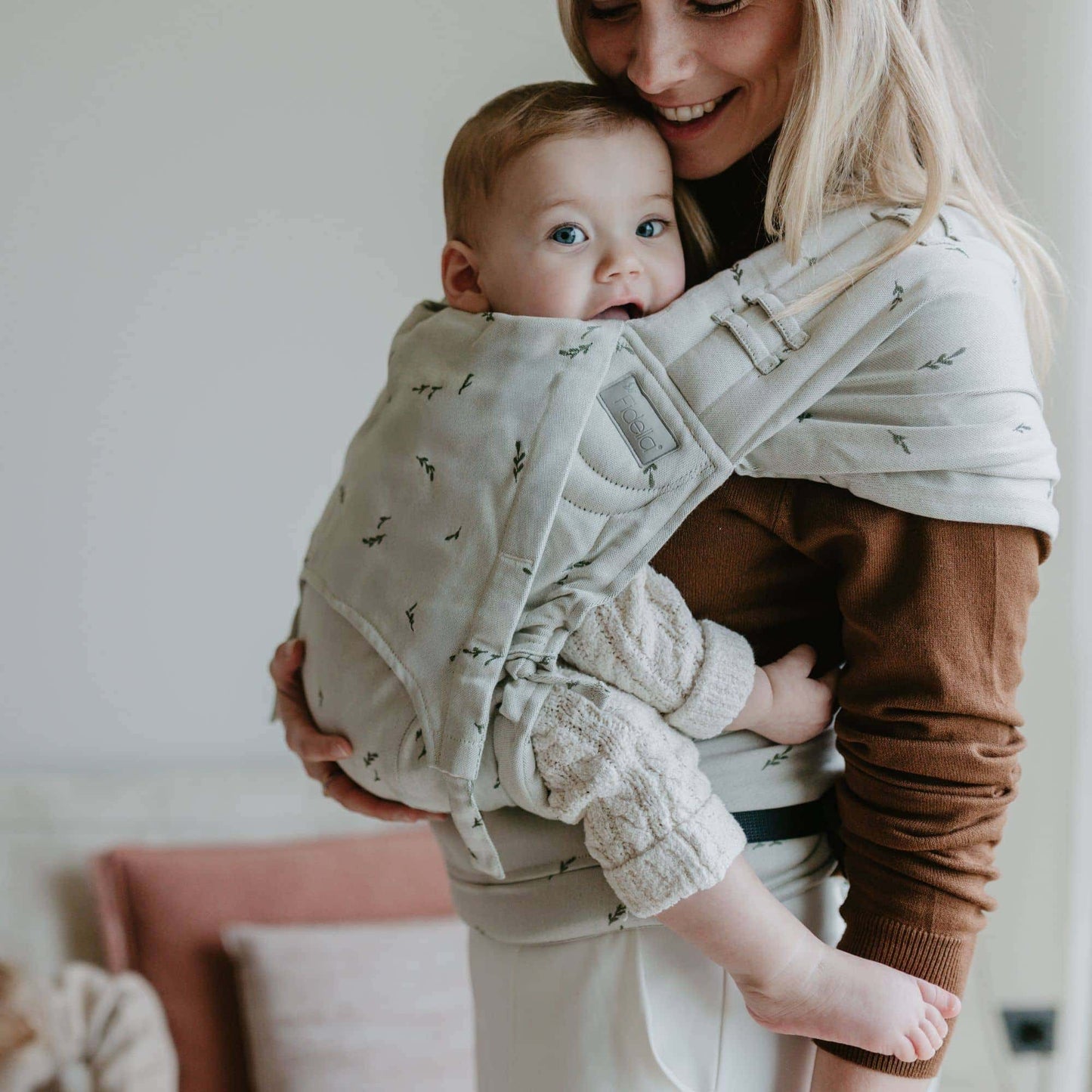 A baby is carried in FlyClick  Half Buckle Baby Carrier Design Leaves  green